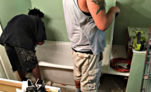 Contractors installing a new tub.